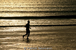 jogging at the beach .. by Patrick Neumann 